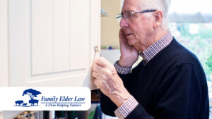 Elderly man looking in cupboard